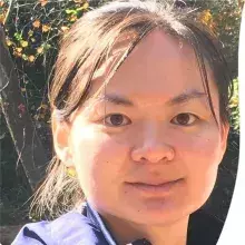 Headshot of CT who is an Asian woman with a round head and black hair