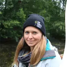 photo of a person standing at river bank